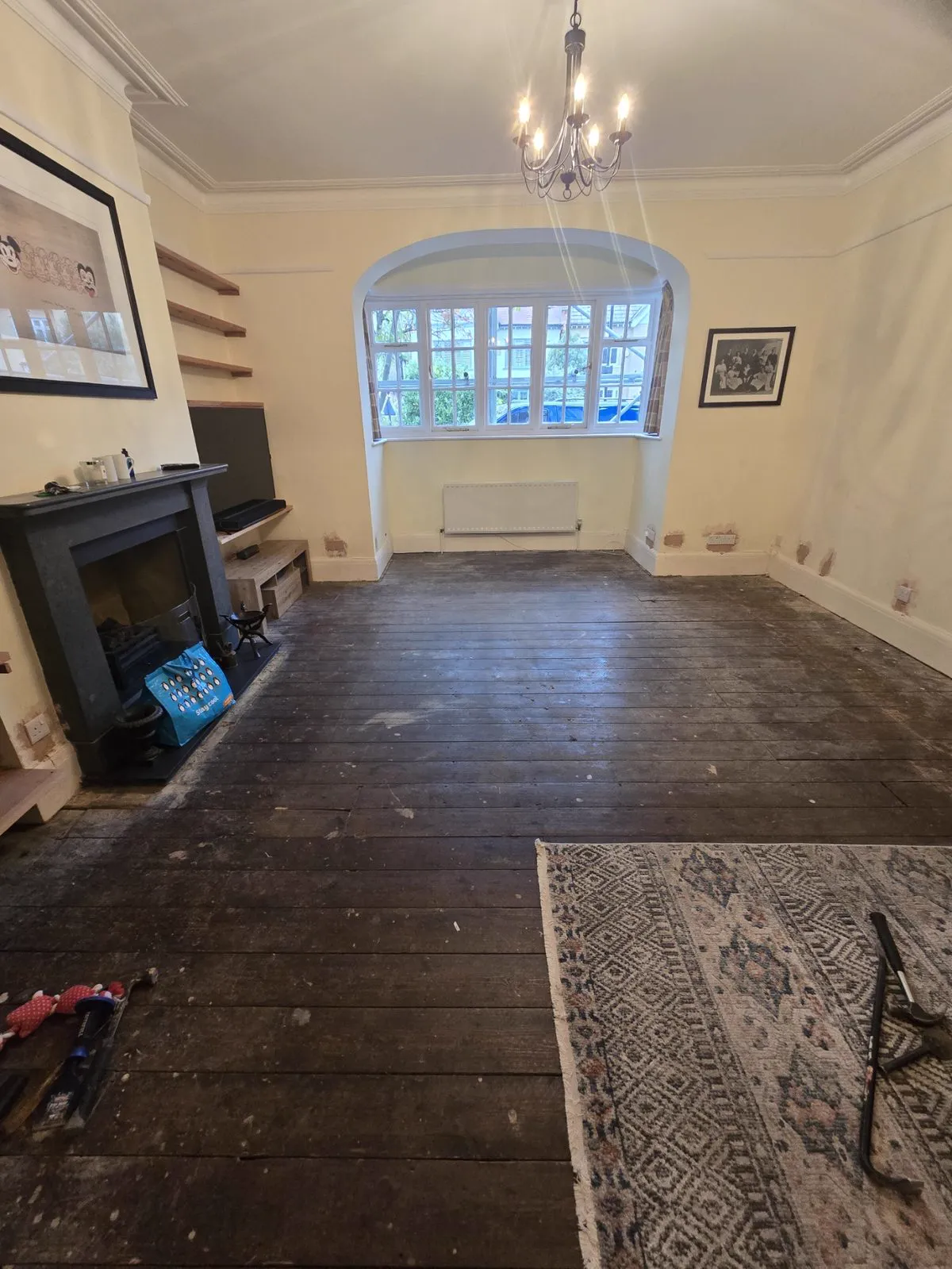 Pine floorboards mid-sand with fresh timber revealed
