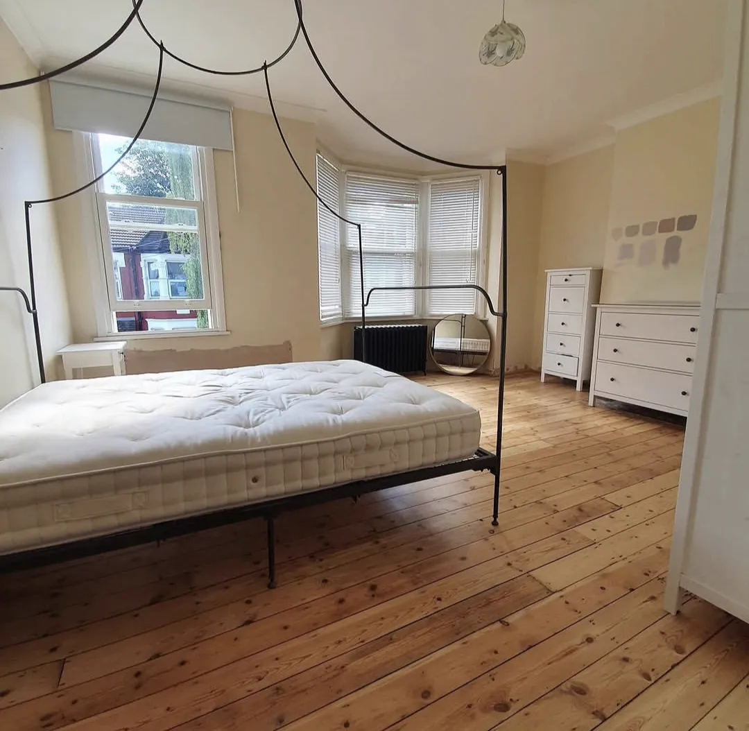 Restored honey pine bedroom floorboards in a Crystal Palace period home
