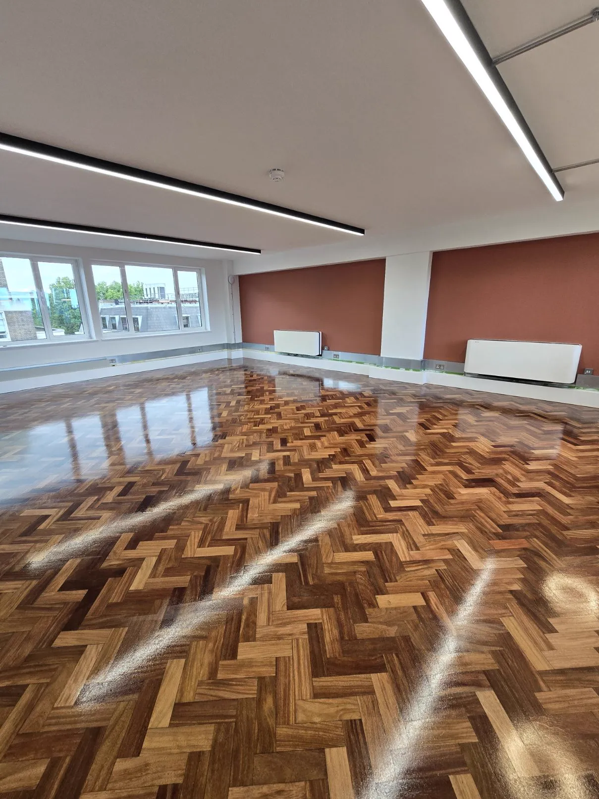 Restored office herringbone parquet floor in Kensington W8 by Howard Naish