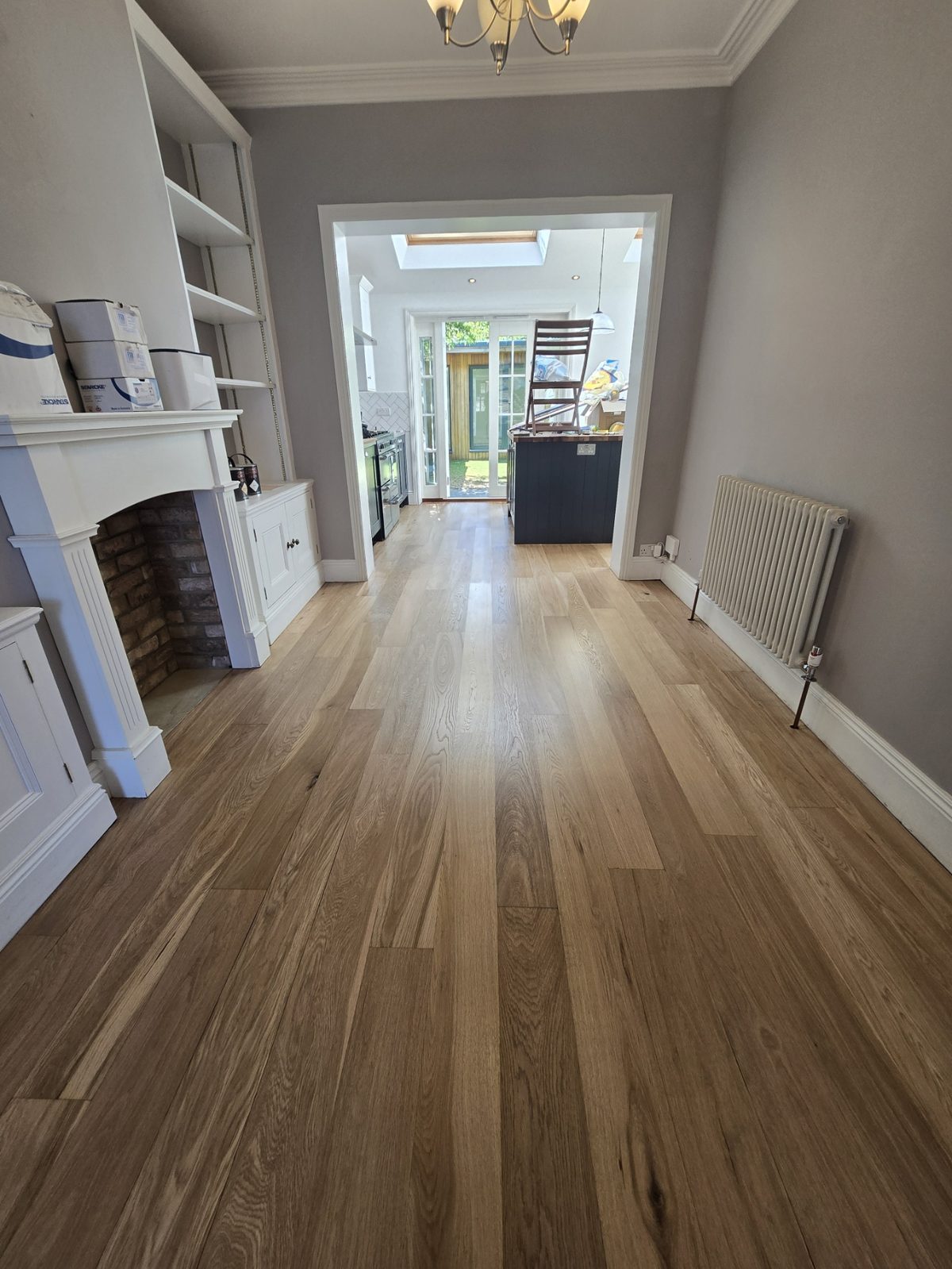 Oak floorboards freshly sanded and finished by Howard Naish, grain glowing in natural light
