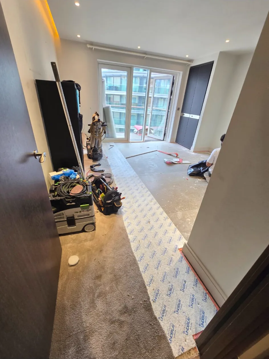 Old carpet lifted to reveal original floorboards waiting to be restored in Putney