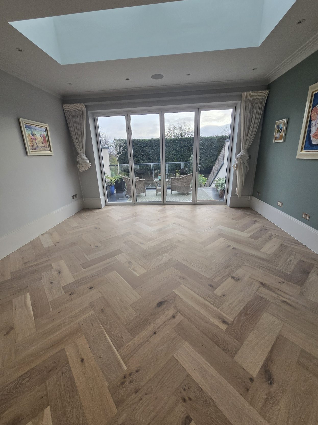 Pale raw-look oak herringbone floor fitted and finished by Howard Naish