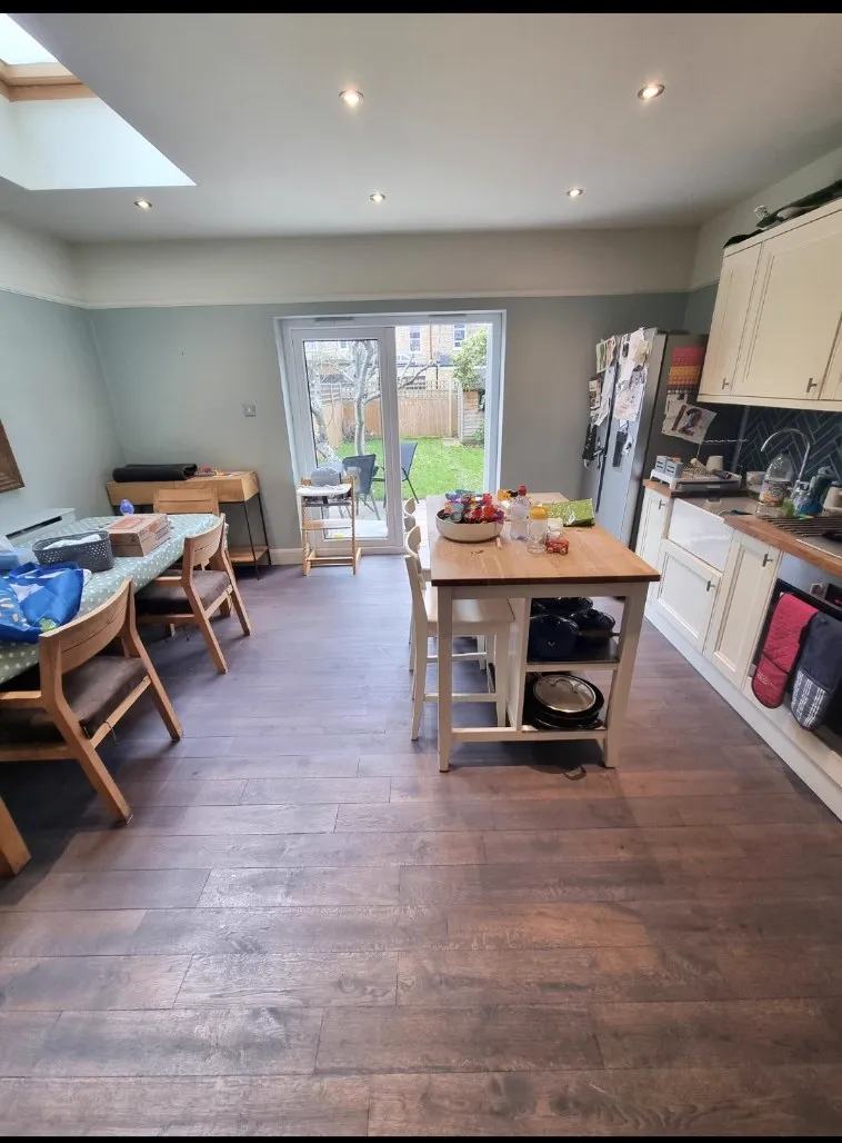 Dark stained wide boards in a Sutton SM1 family kitchen-diner, sanded and stained by Howard Naish