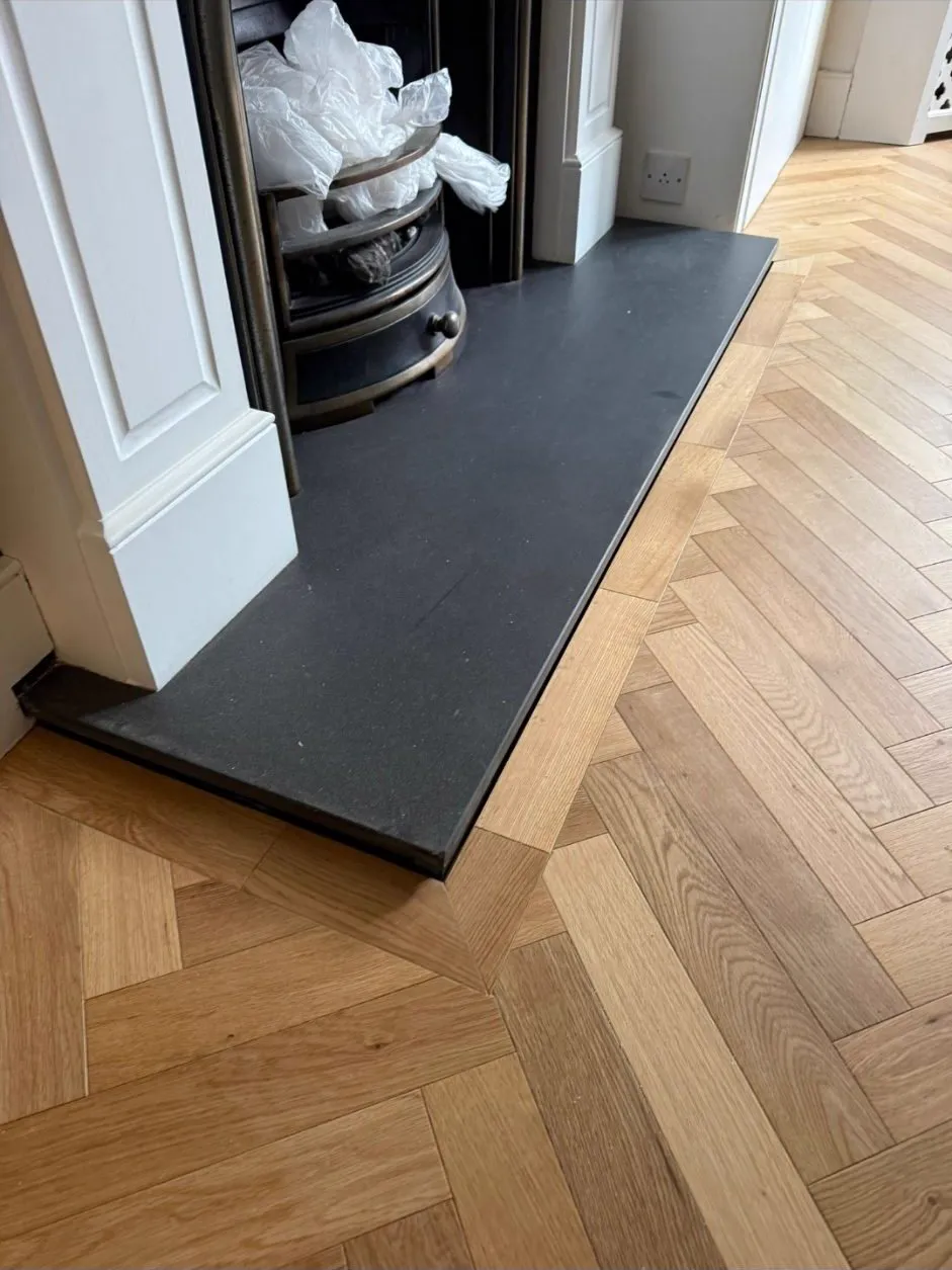 Herringbone parquet scribed to a slate hearth in a Wimbledon SW19 living room by Howard Naish